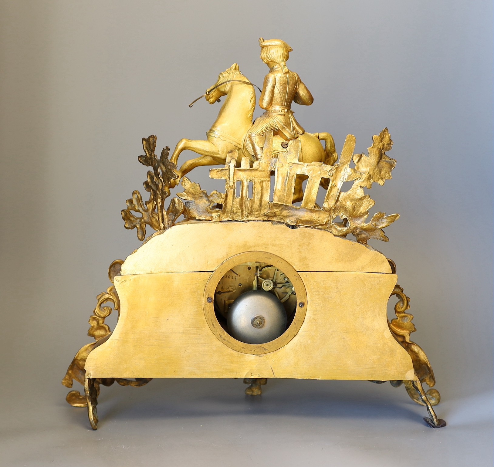 A French gilt metal figurative mantel clock with key and pendulum, 37cms high